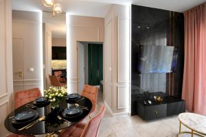 a dining room with a black table and chairs at CoCo Elite Apartments Zator in Zator