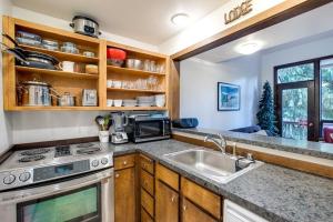 eine Küche mit einer Spüle und einem Herd in der Unterkunft 06SW - Fireplace - WithD - Kitchen - Sleeps 7 home in Glacier
