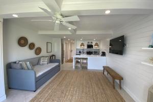 a living room with a couch and a ceiling fan at Bluff Villas 1807 in Hilton Head Island