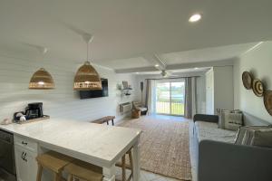 a kitchen and living room with a table and a couch at Bluff Villas 1807 in Hilton Head Island