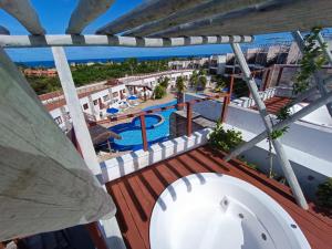 a view from the balcony of a resort with a swimming pool at Pipa Brisas do Amor in Pipa