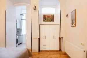 a bedroom with a door leading to a kitchen at Apartment in old TBILISI in Tbilisi City