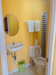 a bathroom with a sink and a toilet and a mirror at Cabañas Martina Surf Playa Guanico in Pedregal +104 photos