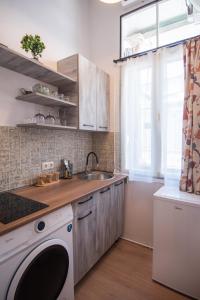a kitchen with a sink and a washing machine at Apartment in old TBILISI in Tbilisi City