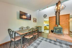 a dining room with a table and a fireplace at Wisconsin Vacation Rental Retreat with Deck in Twin Lakes