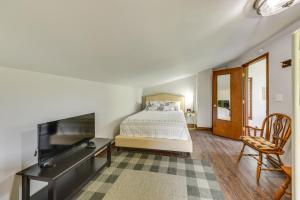 a bedroom with a bed and a desk and a tv at Wisconsin Vacation Rental Retreat with Deck in Twin Lakes