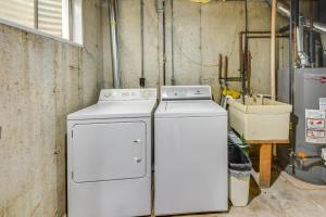 two washing machines sitting next to each other in a room at Wisconsin Vacation Rental Retreat with Deck in Twin Lakes