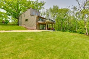 a house on a hill with a large yard at Wisconsin Vacation Rental Retreat with Deck in Twin Lakes