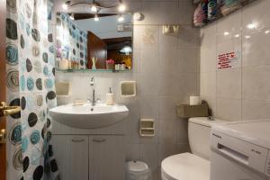 a bathroom with a sink and a toilet and a mirror at Nature Village Apartment in Áyioi Dhéka