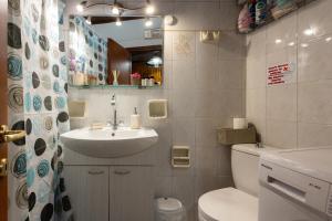 a bathroom with a sink and a toilet and a mirror at Nature Village Apartment in Áyioi Dhéka +9 photos