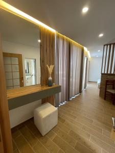 a bathroom with a counter and a mirror and a stool at Apartments Basha 1 - Long Beach in Ulcinj