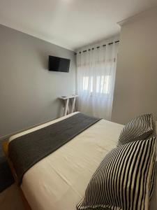 a bedroom with a bed and a television on the wall at Cricket Apartments in Ferrel