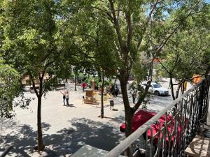 a man is standing on a fence next to trees at Stay U-nique Apartments Rogent in Barcelona