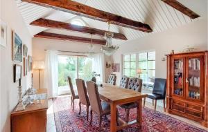 a dining room with a wooden table and chairs at Awesome Home In Genarp With Wifi in Genarp