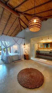 a large room with a bed and a large rug at Vila dos Macacos Trancoso in Trancoso