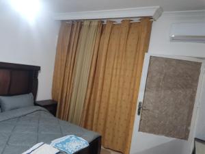 a bedroom with a bed and a window with curtains at Studeo for rent in Amman