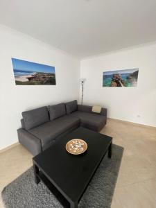 a living room with a couch and a table at Cricket Apartments in Ferrel