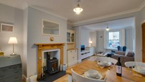 a living room with a table and a fireplace at Woodville Road, Mumbles in The Mumbles