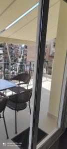 a view of a balcony with a table and chairs at Katia's sunny penthouse apartment in Piraeus