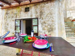 a table with plates of food on top of it at La Rudda di Casa Camilla Journey in Specchia