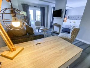 a living room with a couch and a table at Artisan Downtown in De Land