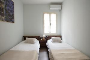 A bed or beds in a room at Poseidon Hotel