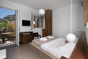 A bed or beds in a room at Poseidon Hotel
