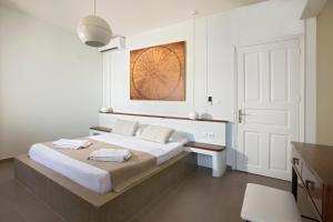 A bed or beds in a room at Poseidon Hotel