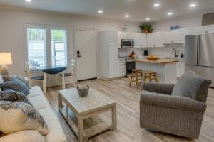 a kitchen and living room with a couch and a table at WFH-Friendly Condo Rental in Nashville, Georgia! 