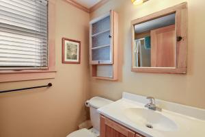 a bathroom with a sink and a toilet and a mirror at Mountain Abbey in Beech Mountain +13 photos