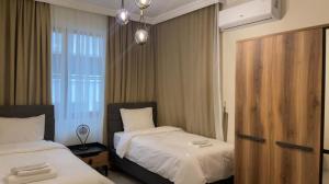 A bed or beds in a room at NQ Luxury Apartment