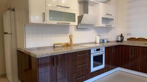 A kitchen or kitchenette at NQ Luxury Apartment