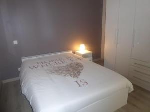 a bedroom with a white bed with a heart on it at la Luna in Lapalme +13 photos