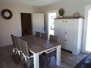 a dining room with a wooden table and chairs at la Luna in Lapalme