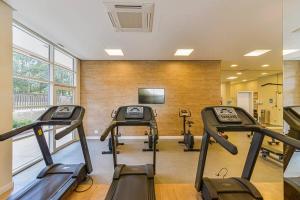 a gym with three treadmills in a room at Flat Completo na Ponte Estaiada SP in São Paulo