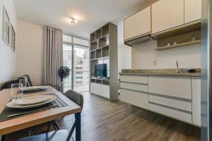 a kitchen with a table and a dining room at Flat Completo na Ponte Estaiada SP in São Paulo