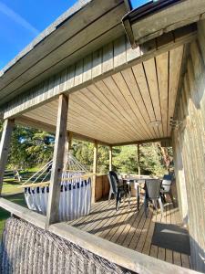 a wooden deck with a table and chairs on it at Männiliiva puhkemaja in Hiiumaa
