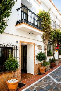 a building with a balcony and potted plants at Marbella Village in Marbella