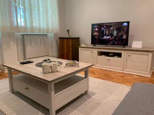 a living room with a coffee table and a tv at Bonaca in Izola