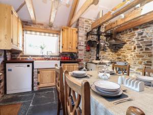 a kitchen with a table with plates on it at Trewince Manor Cottage in Truro