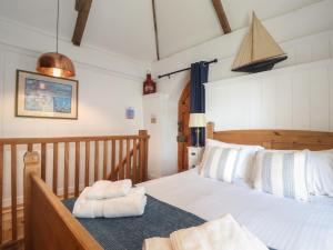 a bedroom with a bed with towels on it at Trewince Manor Cottage in Truro +29 photos