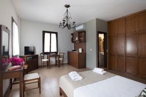 A bed or beds in a room at Poseidon Hotel