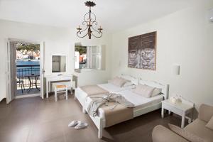 A bed or beds in a room at Poseidon Hotel
