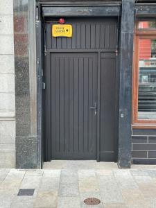 a black garage door with a sign on it at Clanbrassill loft in Dundalk
