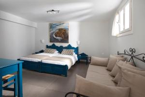 a bedroom with a bed and a couch at Poseidon Hotel in Meyisti