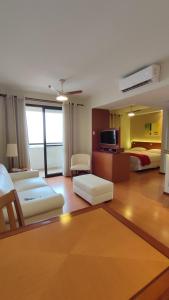 a hotel room with two beds and a living room at New Life Piracicaba by Atlantica in Piracicaba