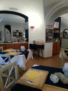 a dining room with a table and a kitchen at Hotel Argentina in Santa Margherita Ligure