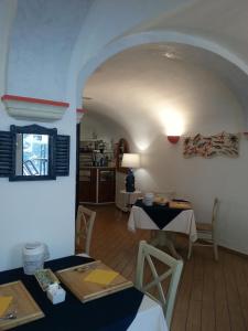 a dining room with two tables and a kitchen at Hotel Argentina in Santa Margherita Ligure