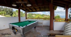 a pool table sitting inside of a room with at Santo Cerro Natural Park Eco Lodge con Vista Panorámica y Experiencias Naturales in Santo Cerro