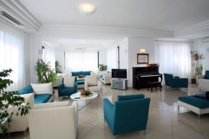 a living room with blue and white furniture and a piano at Bikini Hotel in Vieste